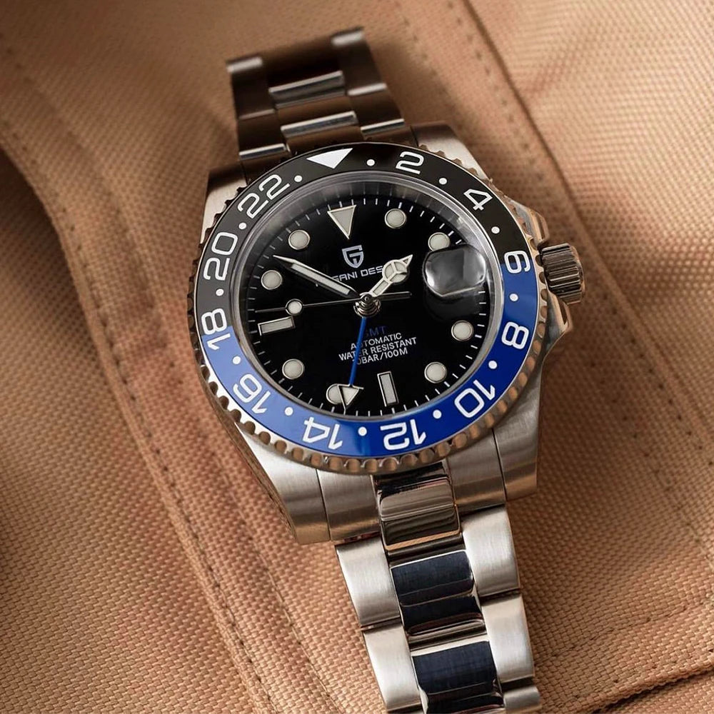 Watch with a silver and blue strap on a brown fabric background