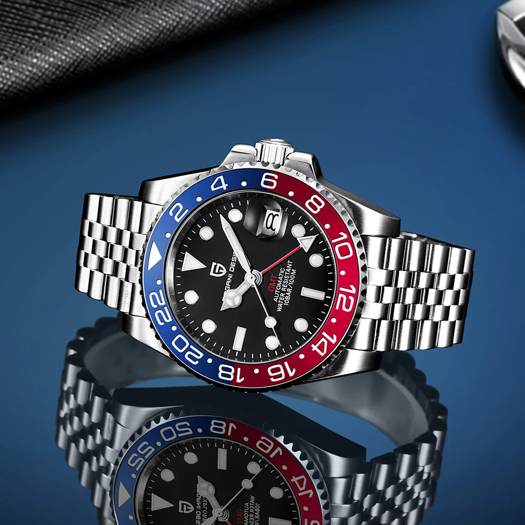 Wristwatch with a silver, blue, and red bezel on a reflective surface with a blue background